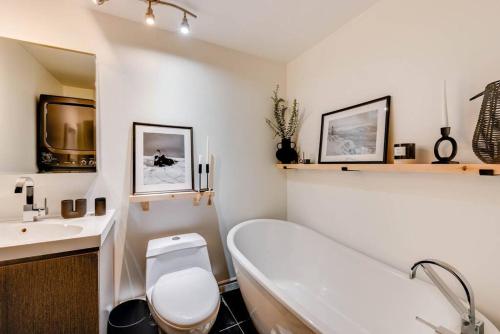 a bathroom with a tub and a toilet and a sink at D-Chalet - 9 personnes - 2 chambres in Beaupré