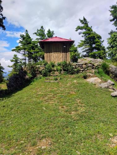 a small building on top of a grassy hill at Homestay in Baglung Bazar -Baglung Homestay in Bāglung