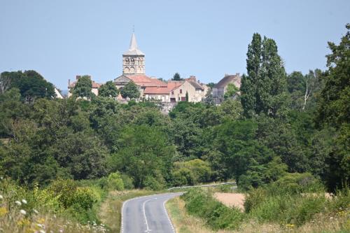 a road in front of a house on a hill at Aux 3 Forêts in Bizeneuille