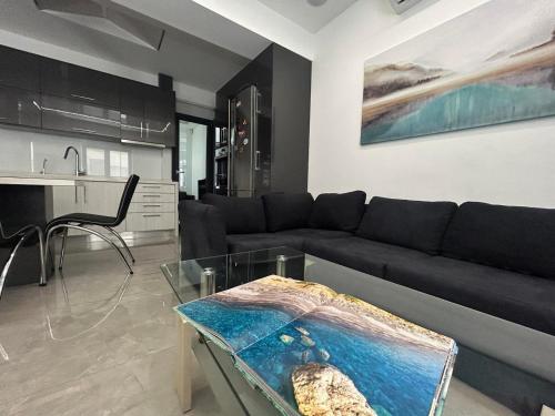 a living room with a couch and a table at Ivory Style Maisonette near Downtown in Heraklio Town