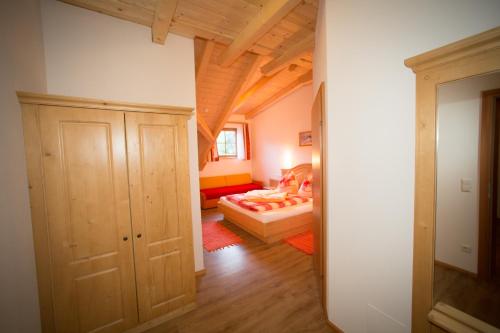 a small room with a bed and a hallway at Rojerhof in Schladming