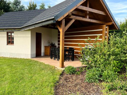 a covered deck with a table and chairs at Chalupa Vrchlabi in Vrchlabí