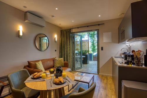 a kitchen and a living room with a table at La Perle de Domme in Sarlat-la-Canéda