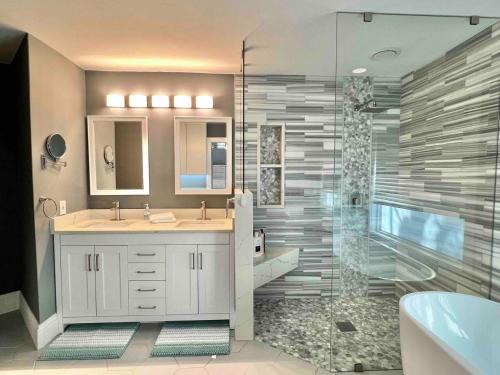 a bathroom with two sinks and a shower at Wellington Pool House With Spa and Putting Green in Wellington