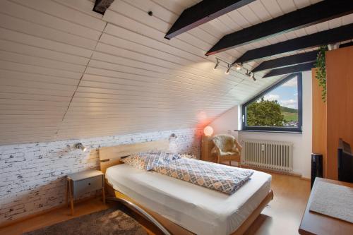 a bedroom with a bed in a room with a window at Ferienwohnung Lux in Plettenberg