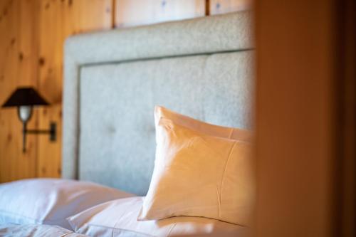 a white pillow sitting on top of a bed at Der Gannerhof in Innervillgraten