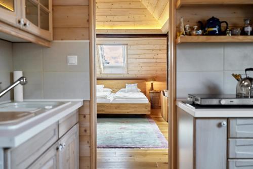 a small kitchen with a bed in a room at Apartmán Dobrá Voda in Toužim