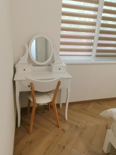a white dressing table with a mirror and a chair at Sweet home 1 in Cahul