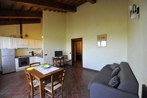 a living room with a couch and a table at Il Podere Del Germano Reale in Coriano
