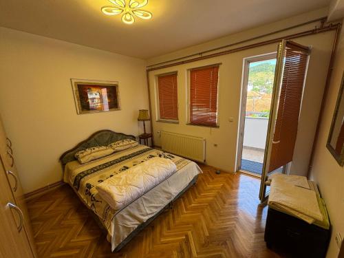 a bedroom with a bed and a large window at ASKonak Apartman Novi Pazar Centar in Novi Pazar