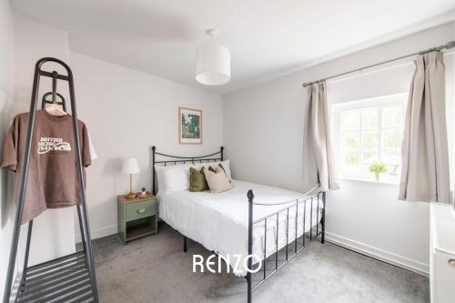 a bedroom with a bed and a window at Gorgeous 2-bed Home in Newark on-Trent by Renzo, Free Parking, Brilliant Location! in Newark upon Trent