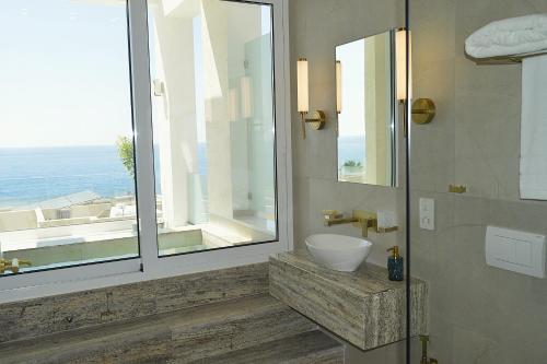 a bathroom with a sink and a large window at Olymp Luxury Family House in Paphos
