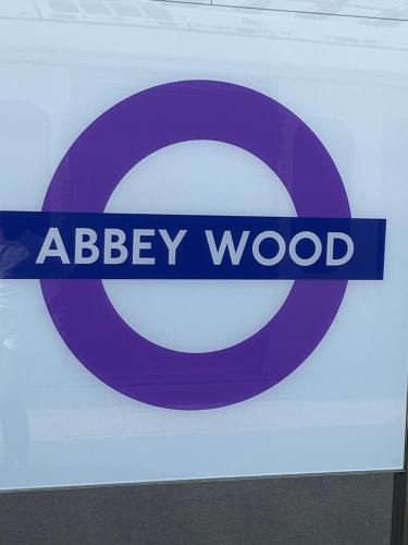 a sign that says abbey wood on a wall at Abbey Wood Serviced Apartment 3BRH Free Wi-Fi Parking Tea and Coffee in Belvedere