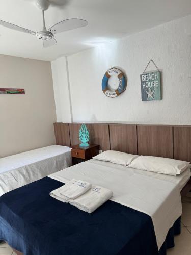 two beds in a room with two towels on them at Pousada Fernandes in Arraial do Cabo