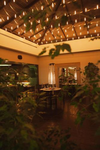 a room with a table and chairs and lights at Austral Plaza Hotel in Comodoro Rivadavia