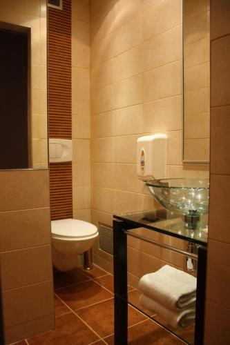 a bathroom with a sink and a toilet at Hôtel Du Midi in Narbonne