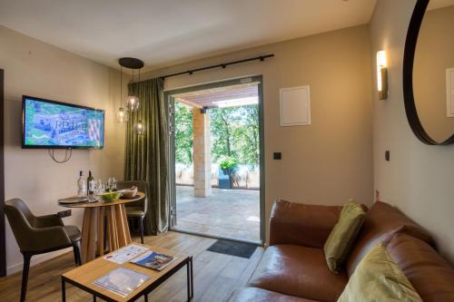 a living room with a couch and a table at La Perle de Domme in Sarlat-la-Canéda