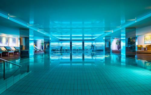 an empty lobby of a building with blue lights at GRAND ELYSEE Hamburg in Hamburg