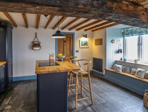 a kitchen with a wooden counter top in a room at Pengarreg in Barmouth