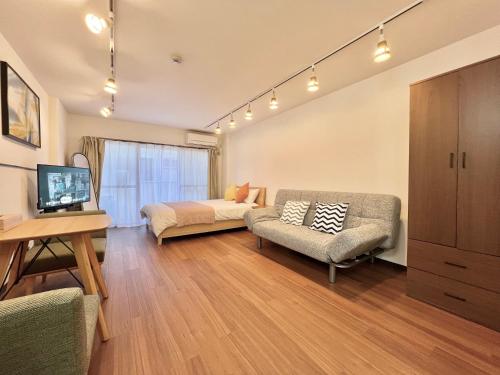 a living room with a couch and a bed at KKHouse in Tokyo