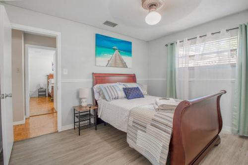 a bedroom with a bed and a chair in it at 4br Orlando Home Pets Family Comfort & Deals in Orlando