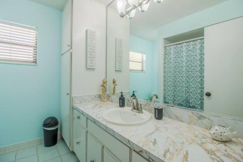 a bathroom with a sink and a mirror at 4br Orlando Home Pets Family Comfort & Deals in Orlando