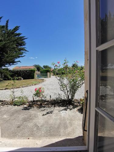 an open door with a view of a yard at Maison la tour in Néré