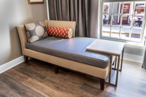 a couch and a table in a room with a window at Hilton Saint Augustine Historic Bayfront in Saint Augustine