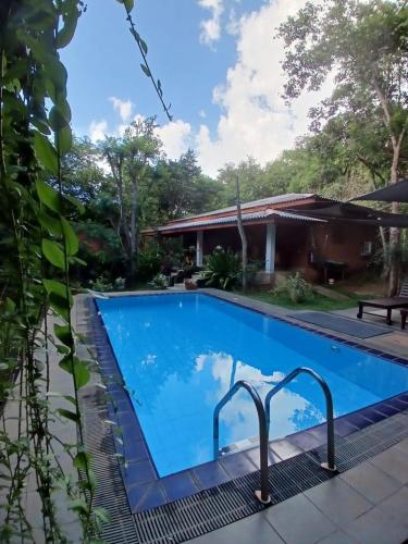 a swimming pool at a villa with a house at Villa Habarana in Habarana