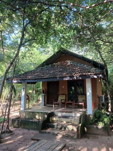 a small house in the middle of a forest at Villa Habarana in Habarana