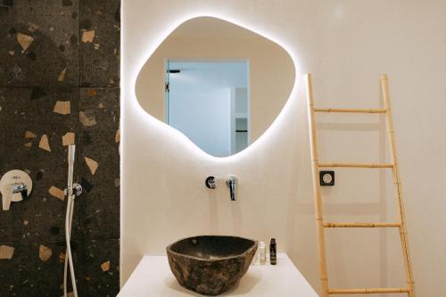 a bathroom with a bowl sink and a mirror at Gazelle Living in Imerovigli