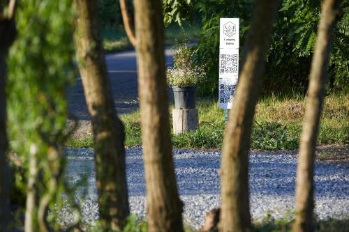 a sign in the middle of a road with trees at Camping Baleia in Pui