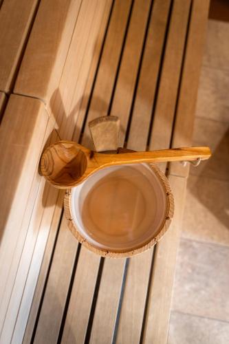 a wooden bowl sitting on top of a wooden table at JUFA Hotel Schladming in Schladming