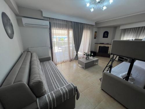 a living room with a couch and a bed at Metaxenia's house 101 in Nea Skioni
