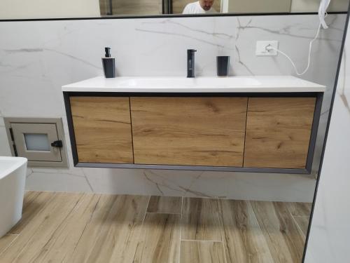 a bathroom with a sink and a mirror at appartament Suoro Palma in Marsala