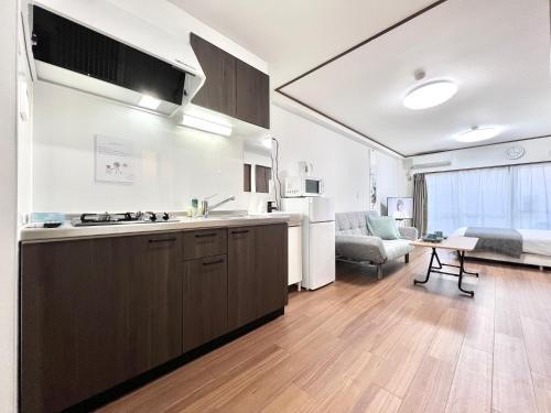 a kitchen and a living room with a couch at KKHouse in Tokyo