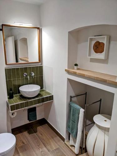 a bathroom with a sink and a toilet and a mirror at Alcova delle Arvolte in Narni