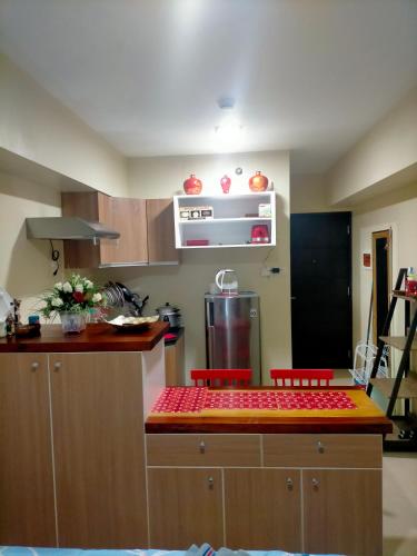 a kitchen with a counter with two red chairs at Avida Towers Riala, Tower 2 in Cebu City