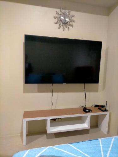 a living room with a large flat screen tv on a wall at Avida Towers Riala, Tower 2 in Cebu City
