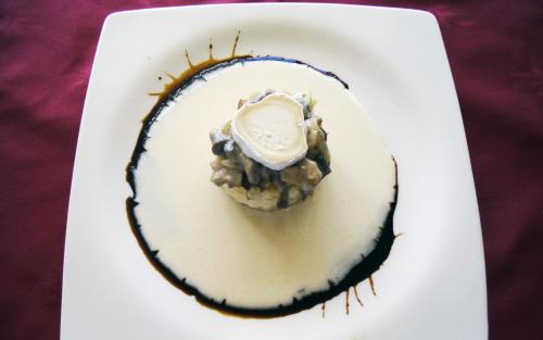 a dessert on a white plate with ice cream on top at Villa Mencia in Corullón