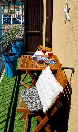a picnic table with two glasses of wine on a patio at Acquadolce in Salò