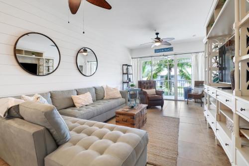 a living room with a couch and a mirror at 7940 # 626, Naples, FL in Naples