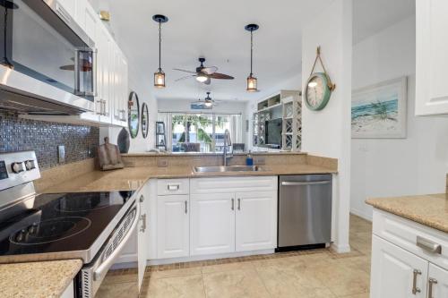 a kitchen with white cabinets and a sink at 7940 # 626, Naples, FL in Naples