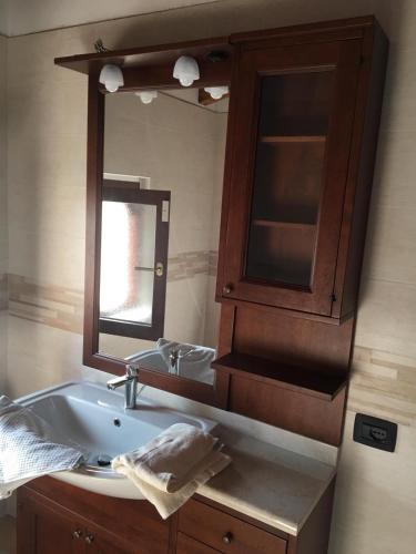 a bathroom with a sink and a mirror at B & B Lmc LA MADONNINA CHALET in Casteggio
