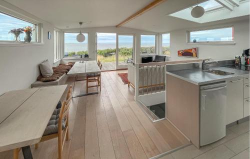 a kitchen and living room with a table and a couch at Awesome Home In Esbjerg V With Wifi in Esbjerg