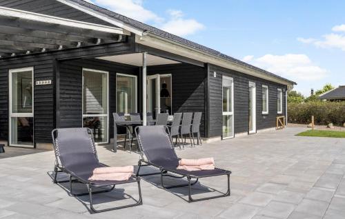 a group of chairs sitting on a patio at Beautiful Home In Hemmet With Wifi in Hemmet