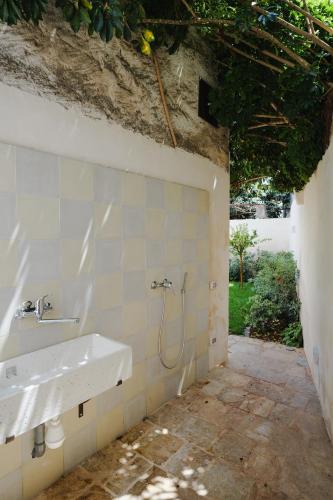 a bathroom with a sink and a shower at PugliaEclectic - A Modern Oasis in the Heart of Puglia in San Vito dei Normanni