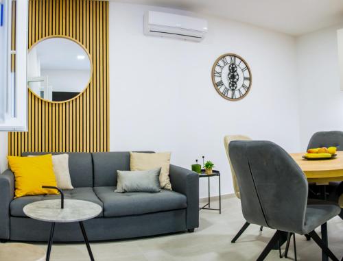 a living room with a blue couch and a table at Apartment Paradise Island in Pučišća