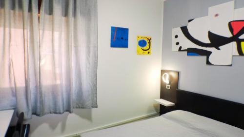 a small bedroom with a bed and a window at soverato sweet home Mirò in Soverato Marina