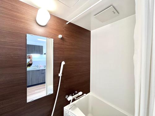 a bathroom with a mirror and a sink at KKHouse in Tokyo